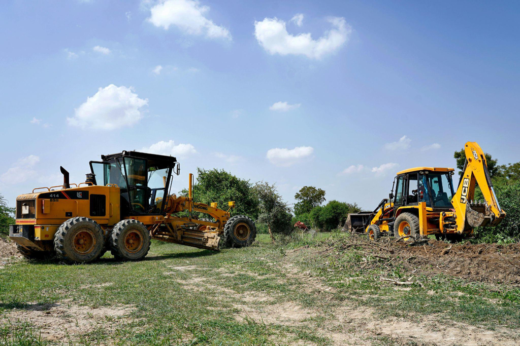 two excavators working on clearing the ground  