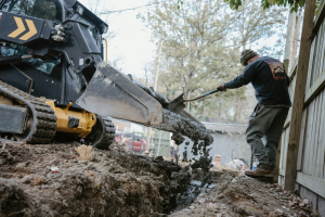 a person taking mud from an excavator