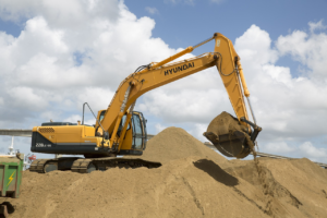an excavator picking up dirt